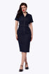 A woman modeling a dark navy blue denim mini dress with short sleeves, a button-up front, and a matching belt, set against a plain white background.